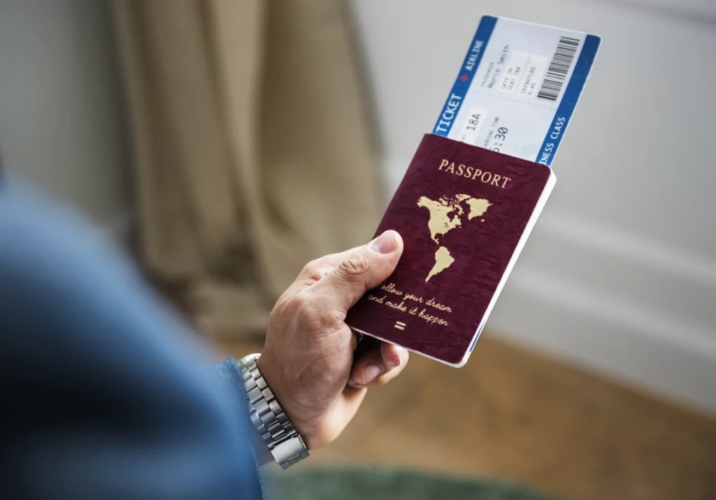 Business traveller holding a passport and boarding pass
